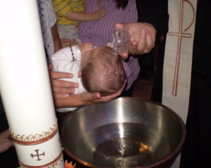 This is Boo actually BEING baptized.  In the act of being baptized.  By a priest.  In a church.  With his mother, me, watching as if  lobotomized in the background wearing the purple blouse holding his brother.
